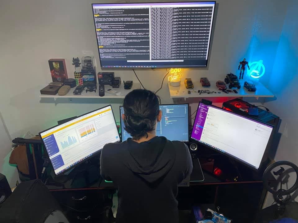 Alkein Villajos at his three-monitor home workspace